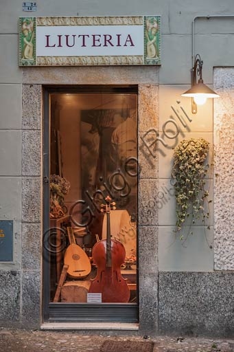 Inside a luthier's workshop in Cremona with violins and handcrafting tools