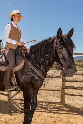 Buttero on horseback in the landscape of Maremma Regional Park, Tuscany Italy