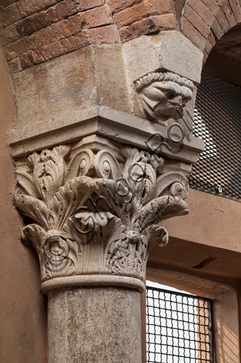Sculptural detail of human face on Corinthian capital, Ghirlandina Tower, Modena