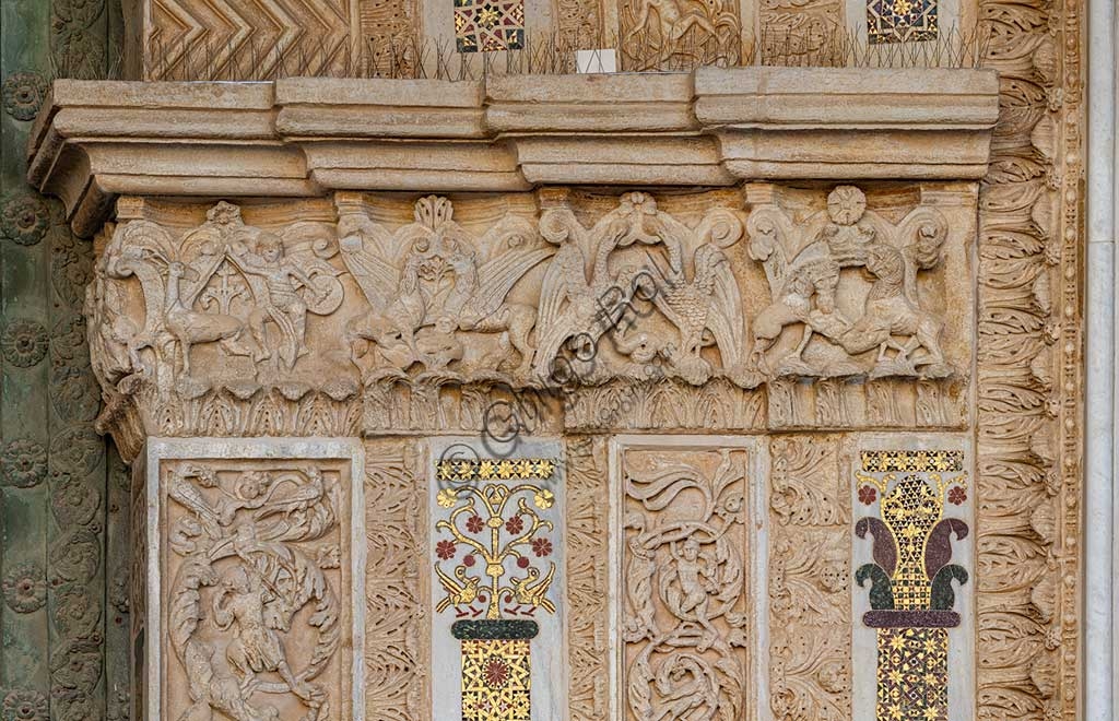 Sculptural detail with human and animal figures on the portal of Monreale Cathedral, Sicily
