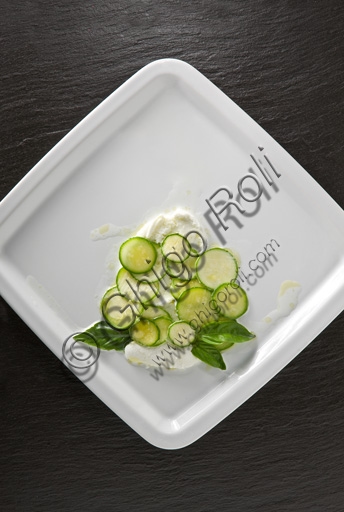 Fresh summer plate with mozzarella, sliced zucchini and fresh basil leaves