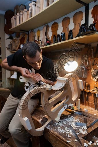 Stefano Conia the young working in his luthier workshop in Cremona
