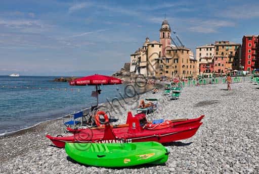 View of Camogli Beach: Umbrellas, Paddle Boat and the Assunta Church
