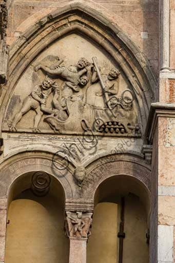 Sculptural detail of the Lunette of the Damned on the Romanesque-Gothic façade of Ferrara Cathedral (St. George's Cathedral)