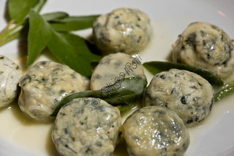 Plate of Tuscan malfatti pasta with melted butter and fresh sage leaves, traditional recipe