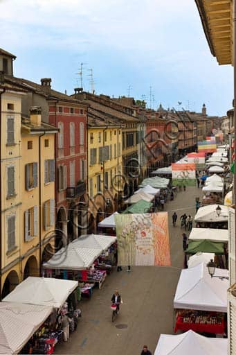 View of Emilia San Pietro Street in Reggio Emilia with market stalls lining the road