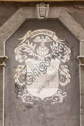 Heraldic Emblem on the Façade of a Historic Hotel in Bormio