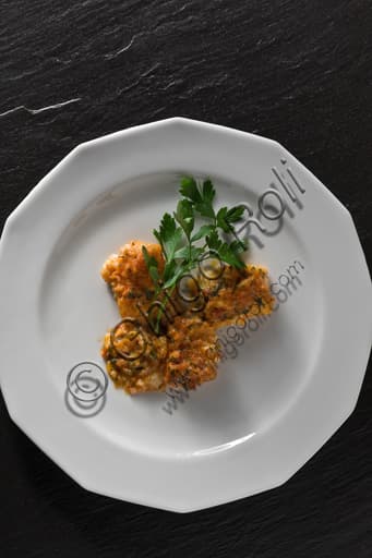 Traditional Bacalau a Bras codfish stew in a dish garnished with fresh parsley