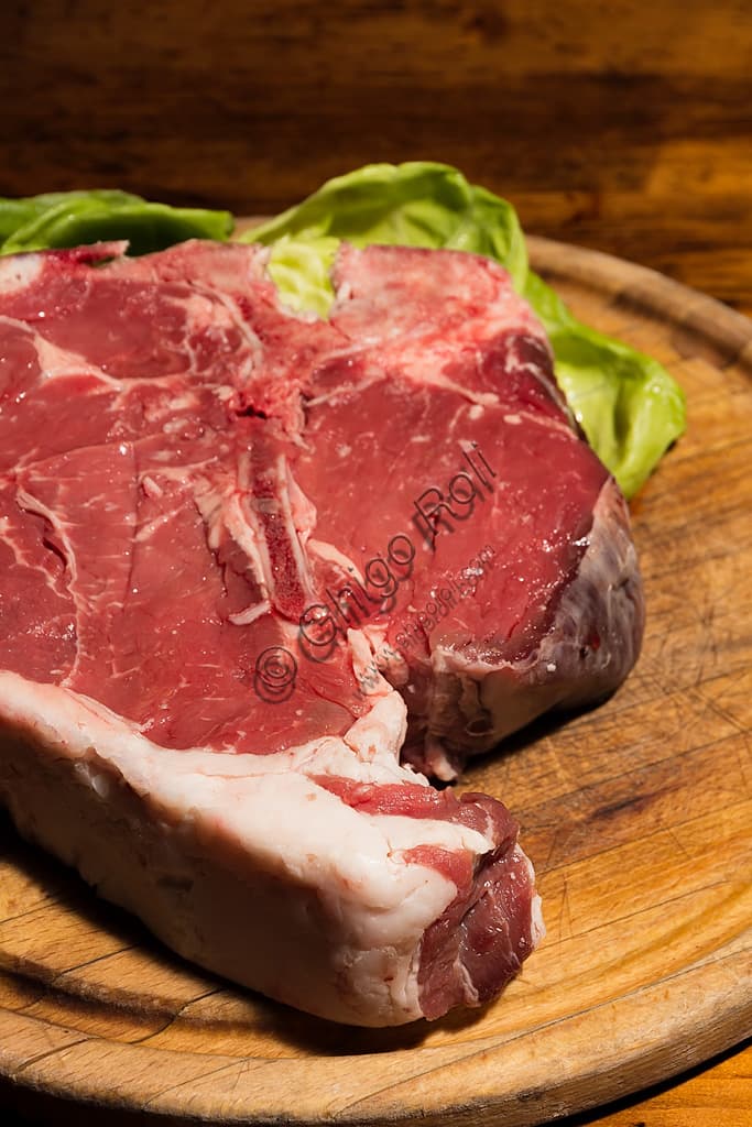 Florentine steak, a T-bone cut of Chianina beef grilled over embers, iconic dish of Tuscan cuisine and Italian culinary tradition
