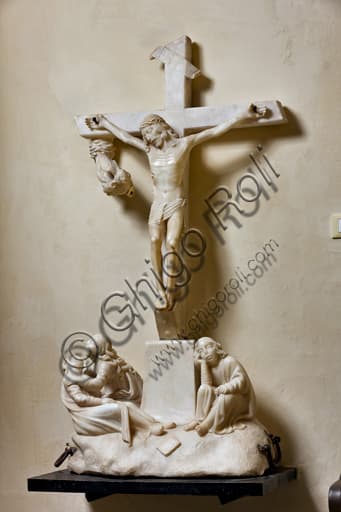 Processional white marble crucifix sculpture by unknown artist in the Baptistery of St. Lawrence Cathedral, Genoa, Italy