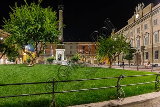 Night view of the illuminated façade of the Episcopal Palace and the Gardens of Piacenza