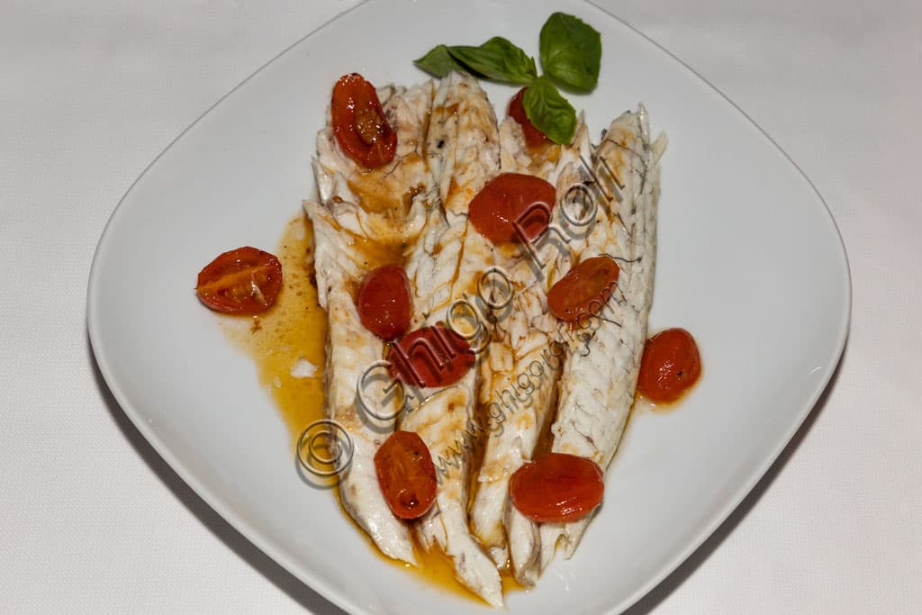 Sea bass cooked acqua pazza style with tomatoes and basil, Italian seafood dish from Trattoria Il Fontanone, Brescia