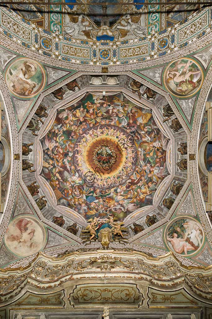   Saronno, Shrine of Our Lady of Miracles: the dome of the transept with the great fresco "Assumption of the Blessed Virgin", known as "The choir of angels playing music" painted by Gaudenzio Ferrari from 1534.Paradise is essentially represented by the multitude of angelic presences, placed to crown the face of God and to welcome the arrival of the Virgin.The angels playing music constitute the most varied orchestra of stringed and percussion instruments that has never been painted.Fifty-six different musical instruments can be identified, the most recognizable ones are ancient instruments, the others have been created by  the artist's imagination. The following instruments are recognized: alpenhorn (horn of the Alps), altobasso, harp, bombard, cimballini or small plates, bagpipes, cornet, flute, pan or syringe flute, hurdy-gurdy, lyre, lute, nyastaranga,ribeca, viella, salterio or zither, tambourine , timpani, triangle, trumpet, viola.