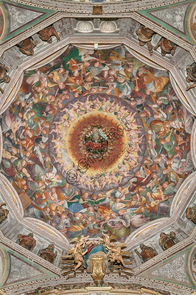   Saronno, Shrine of Our Lady of Miracles: the dome of the transept with the great fresco "Assumption of the Blessed Virgin", known as "The choir of angels playing music" painted by Gaudenzio Ferrari from 1534.Paradise is essentially represented by the multitude of angelic presences, placed to crown the face of God and to welcome the arrival of the Virgin.The angels playing music constitute the most varied orchestra of stringed and percussion instruments that has never been painted.Fifty-six different musical instruments can be identified, the most recognizable ones are ancient instruments, the others have been created by  the artist's imagination. The following instruments are recognized: alpenhorn (horn of the Alps), altobasso, harp, bombard, cimballini or small plates, bagpipes, cornet, flute, pan or syringe flute, hurdy-gurdy, lyre, lute, nyastaranga,ribeca, viella, salterio or zither, tambourine , timpani, triangle, trumpet, viola.