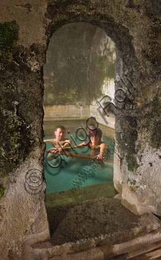  Bormio, Spa,  the thermal baths "Bagni Vecchi": a couple of guests in one of the pools of the Roman Baths.