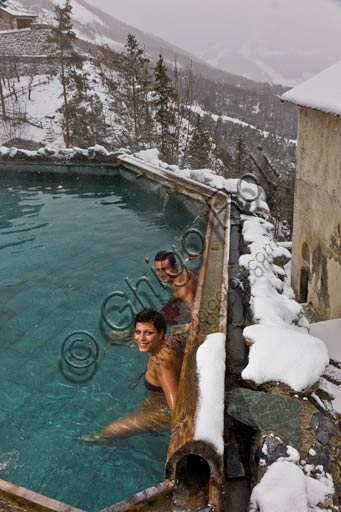  Bormio, Spa,  the thermal baths "Bagni Vecchi": a couple of guests in the open air pool.
