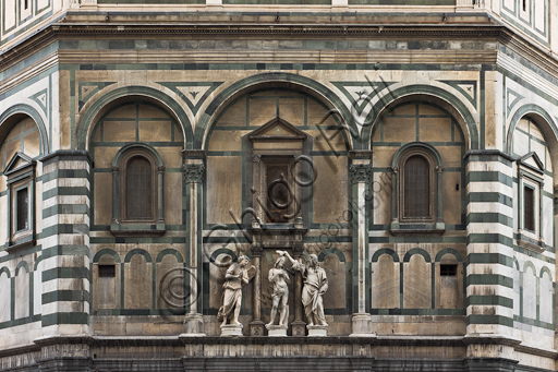 Florence, the Baptistery of St. John, exterior, the Eastern   façade in Carrara white marble and green Prato marble:  detail of "The Baptism of Christ" (copy of the original statues in the Opa Museum) by Andrea Sansovino, (1467-1529), Vincenzo Danti (1530-1576) and Giuseppe Spinazzi (1726-1798).