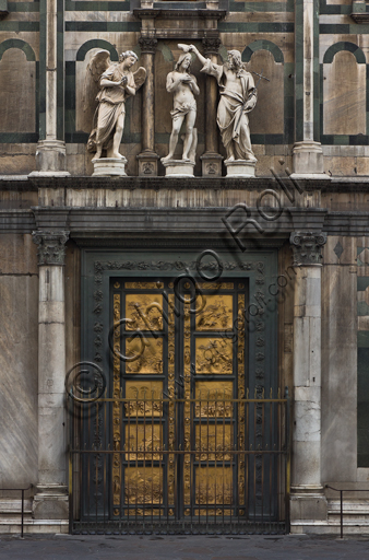 Florence, the Baptistery of St. John, exterior, the Eastern   façade in Carrara white marble and green Prato marble:  detail of the Door of Paradise by Lorenzo Ghiberti and of "The Baptism of Christ" (copy of the original statues in the Opa Museum) by Andrea Sansovino, (1467-1529), Vincenzo Danti (1530-1576) and Giuseppe Spinazzi (1726-1798).