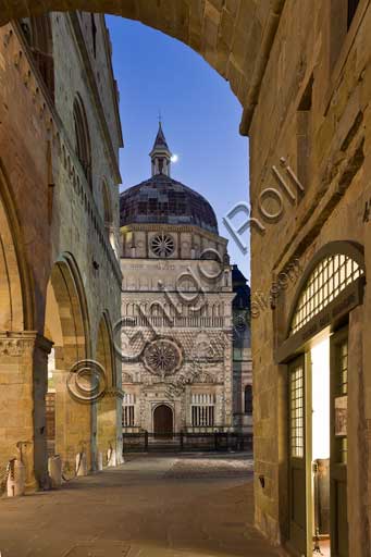 Bergamo, Città alta: night view of  the porch of  Palazzo della Ragione (Ragione Palace). In the background,  the Colleoni Chapel.