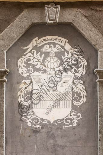  Bormio: emblem on the façade of a historic hotel in the centre.