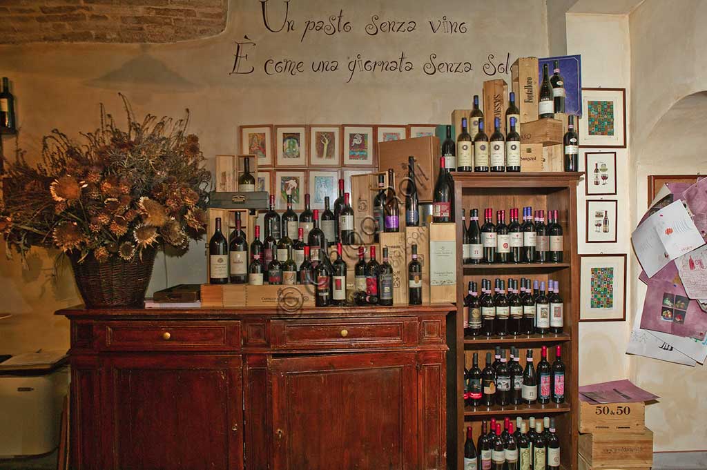 Bevagna, the "Bottega Di Piazza Onofri", wine shop and restaurant: shelves with bottles of red wine.