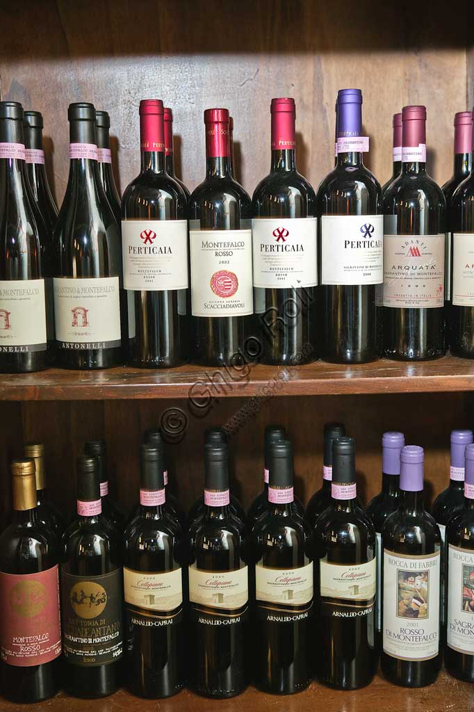 Bevagna, the "Bottega Di Piazza Onofri", wine shop and restaurant: shelves with bottles of red wine.