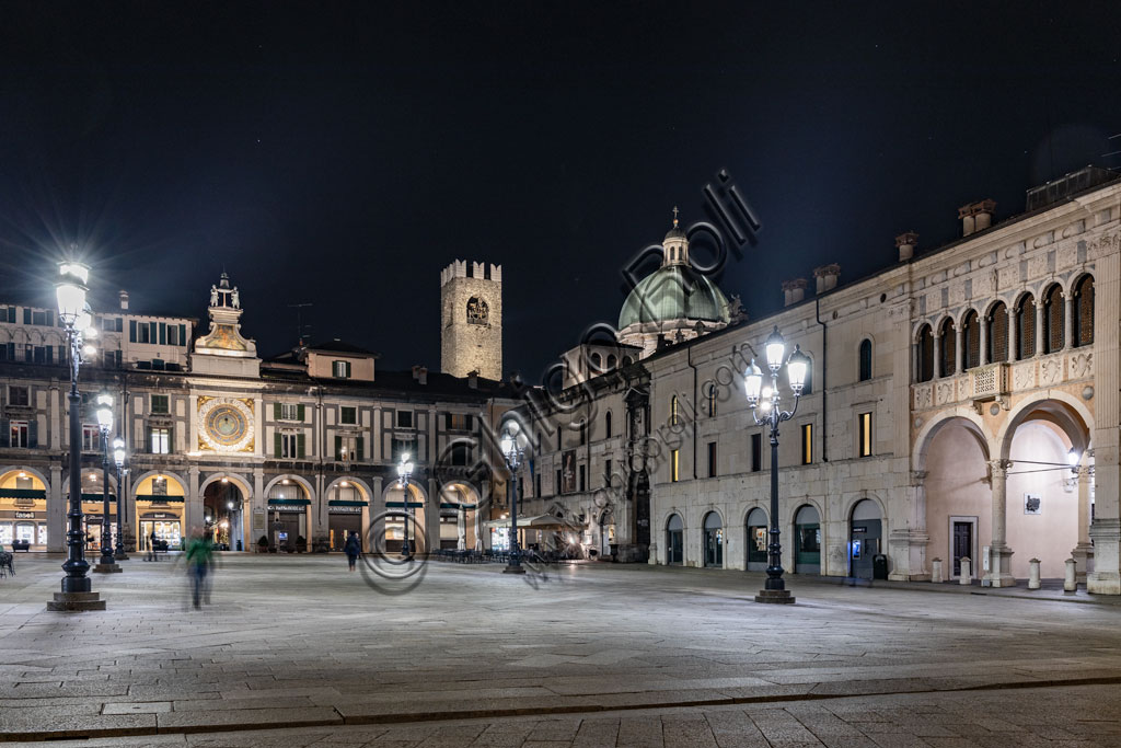 Brescia, piazza della Loggia (a Renaissance square where the Venetian influence is evident):  night view. In the background, from the left, the Clock Tower, the Pégol Tower and the dome of the New Duomo.