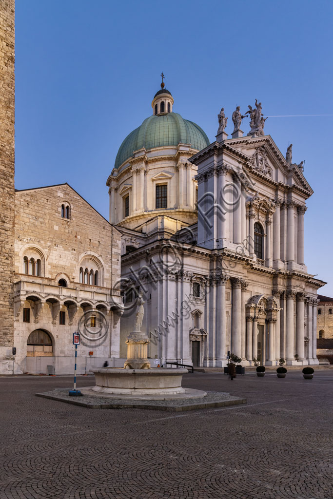 Brescia, Paolo VI Square: from the left, the Broletto with the Pégol Tower and the Loggia delle Grida;  the Duomo Nuovo  (the New Cathedral) , in late Baroque style with the facade of Botticino marble. On the right, you can see the circular structure of the Duomo Vecchio (Old Cathedral).