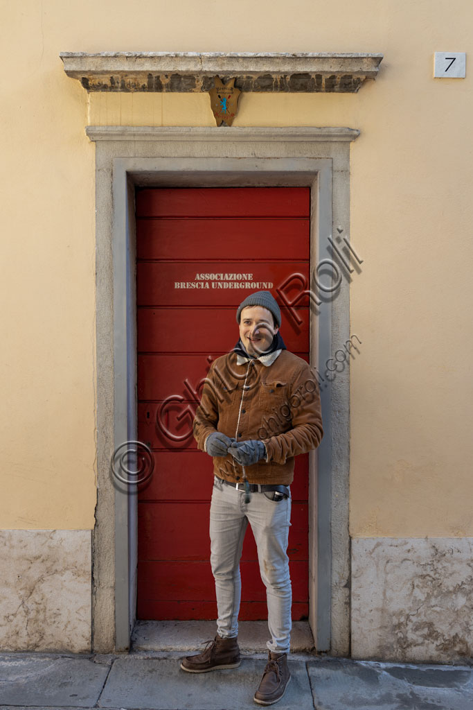 Brescia. "Brescia Underground" Association: the president, Andrea Busi, in front of the "Red Door", the entrance to the Serraglio, one of the most important underground areas of the city.