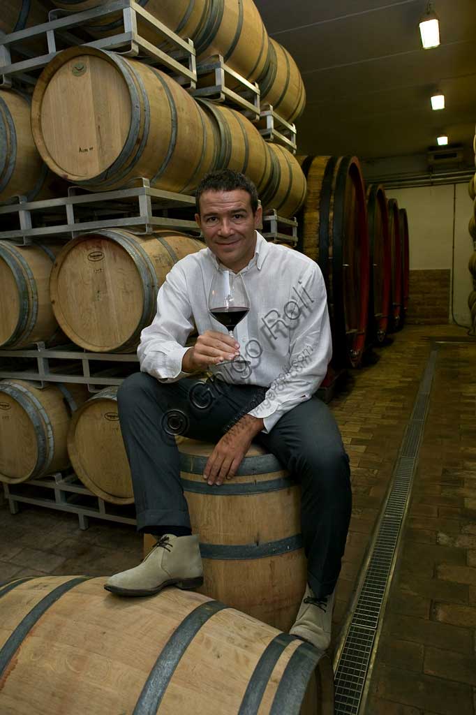 Winery Arnaldo Caprai: Marco Caprai, owner of the "Cantina Arnaldo Caprai" amont the barrels of the Sagrantino wine of Montefalco.