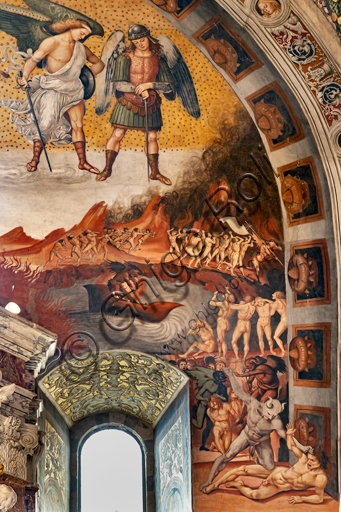  Orvieto,  Basilica Cathedral of Santa Maria Assunta (or Duomo), the interior, Chapel Nova or St. Brizio Chapel, southern wall:  "Call to Hell", fresco by Luca Signorelli, (1500 - 1502). Detail showing the Antehell, taken from Dante's description. A group of slothers has a demon bearing a white banner, while in the centre you can see Charon ready to ferry the damned, destined, lower down, to the judgment of Minos. The latter is portrayed when he commits punishment to a damned man by a demon's hair, wrapping his tail around his body as many times as the number of the group he is destined for. Further on, on the "proscenium", a devil with blue flesh makes to hit a damned man by holding his hair: the crudeness of the scene interested Michelangelo, who in fact copied it.