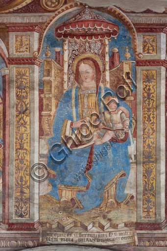 Chiesa di San Defendente, affreschi sotto la lunetta del portale (1483): Madonna in trono con Bambino.