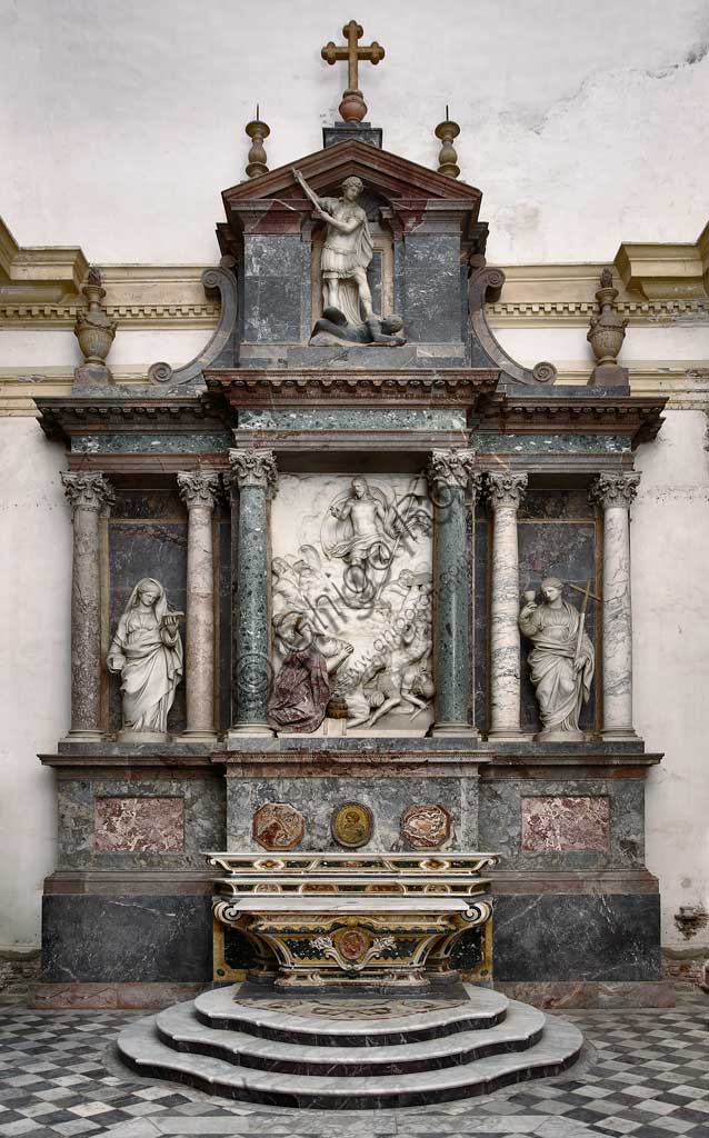 Church of Santa Croce, Mausoleum of St. Pius V: a high-relief in white marble representing  the Resurrection and Pius V in prayer. At the top, statue of St Michael defeating the devil. At the sides, the theological virtues: Faith and Charity. Based on a design by Giovanni Antonio Buzzi (1568-1571).