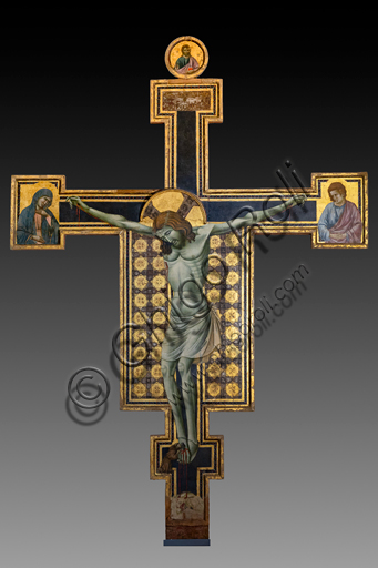 Montefalco, Museum of St. Francis: "Crucified Christ", by the expressionist master of St. Chiara. On the cimasa the Redeemer, on the sides the Virgin and St. John, at the feet of the cross St. Francis of Assisi. Tempera on moulded panel, beginning of XIV century