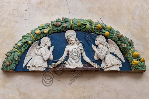 Basilica of the Holy Cross: "Christ in Piety between two Adoring Angels", 1480-90, by Andrea Della Robbia, lunette, bas-relief polychrome glazed terracotta.