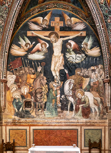 Montefalco, Church of St. Claire, Chapel of St. Claire: "Crucifixion", painted in 1333 by the first Master of St. Clare of Montefalco. The painting is based on the gospels of Luke and John. In the lower right corner the kneeling client, Jean D'Amiel, rector of the Duchy of Spoleto, sad St. John the Evangelist and a centurion. On the left the suffering Madonna and, at the feet of the Cross, Magdalene.