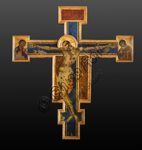 Basilica of the Holy Cross: Crucifix", (1272-80) by Cimabue, tempera on wood. On the sides of Christ on the cross, the Madonna and St. John the Evangelist.The cross bears the iconography of the Christus patiens, that is, a dying Christ on the cross, with his eyes closed, his head resting on his shoulder and his body arched to the left.