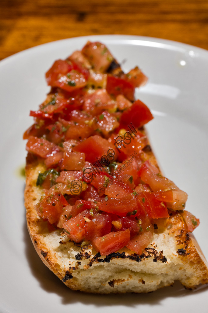 Typical Tuscany cuisine: tomato bruschetta (toasted bread seasoned with oil and sliced tomatoes)