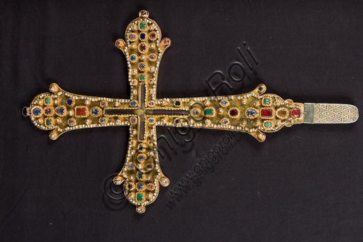   Genoa, Museum of the Treasury of the Cathedral of San Lorenzo: cross reliquary containing a relic of the Sacred Cross of Jesus, called "Of the Zechariahs", Byzantine goldsmith of the thirteenth century; gilded silver, pearls, emeralds, rubies, sapphires, garnets, agate, carnelian, and rock crystal. It was commissioned in the ninth century by Barda, brother of Teodolinda and Emperor of the East. He donated it to the Basilica of St. John the Evangelist in Ephesus. It was remade between 1260 and 1283 by Isaac, bishop of Ephesus. It was later recaptured by the Genoa family of Zachariahs, who donated it to the Cathedral.