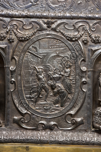   Genoa, Museum of the Treasury of the Cathedral of San Lorenzo: Antependium of altar called  "of Corpus Christi". Melchior Suez 1599, embossed and cast silver. The four evangelists are depicted inside the niches, in the ovals the martyrs  St. John the Baptist, St. Lawrence, St. Sebastian. Detail of the oval with the martyrdom of St.  John the Baptist.