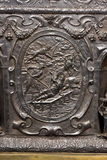   Genoa, Museum of the Treasury of the Cathedral of San Lorenzo: Antependium of altar called  "of Corpus Christi". Melchior Suez 1599, embossed and cast silver. The four evangelists are depicted inside the niches, in the ovals the martyrs  St. John the Baptist, St. Lawrence, St. Sebastian. Detail of the oval with the martyrdom of St.  Lawrence.