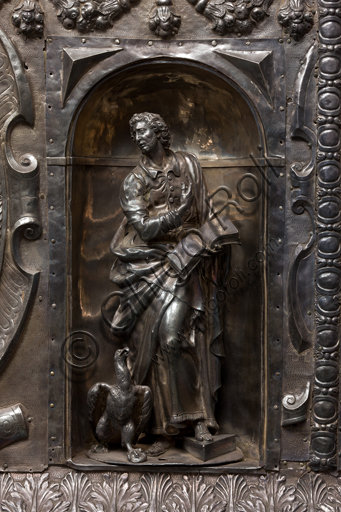   Genoa, Museum of the Treasury of the Cathedral of San Lorenzo: Antependium of altar called  "of Corpus Christi". Melchior Suez 1599, embossed and cast silver. The four evangelists are depicted inside the niches, in the ovals the martyrs  St. John the Baptist, St. Lawrence, St. Sebastian. Detail of the niche with St.  John the Evangelist.