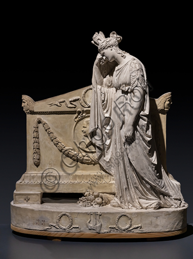  "Model of the Monument to Vittorio Alfieri", 1806, by Antonio Canova (1757 - 1822), plaster. Above a high oval base, surmounted by a further staircase, decorated with festoons and a dedicatory epigraph, there is the sarcophagus which is decorated the profile portrait of the poet carved on the pediment within a medallion with the inscription "VICTORIVS ALFERIVS ASTENSIS". The mourning figure is an allegory of Italy and mourns the loss of one of his most esteemed children, in the composed and solemn attitude of an ancient matron.