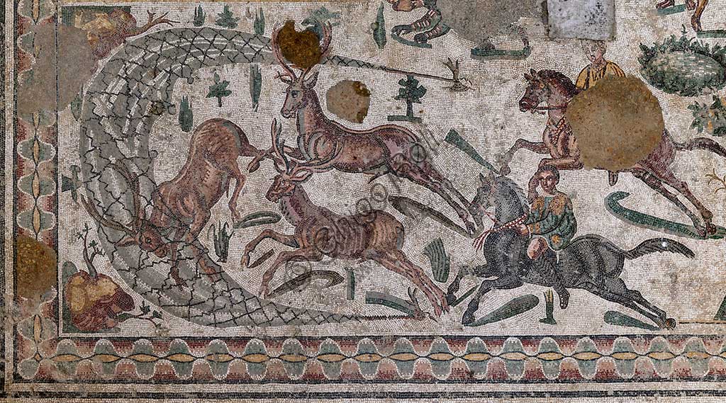 Piazza Armerina, Roman Villa of Casale, which was probably an imperial urban palace. Today it is a UNESCO World Heritage Site. Detail of the floor mosaic in the corridor of the Grat Hunt. Detail with  the capture of deer.In spite of the name with which it is known (The Great Hunt), the subject of the floor mosaic represents a great capture. It does not represent  hunting.Wild beasts are captured for the games in the amphitheatres of the Roman Empire: no animal is in fact shot down and hunters use only weapons to defend themselves.