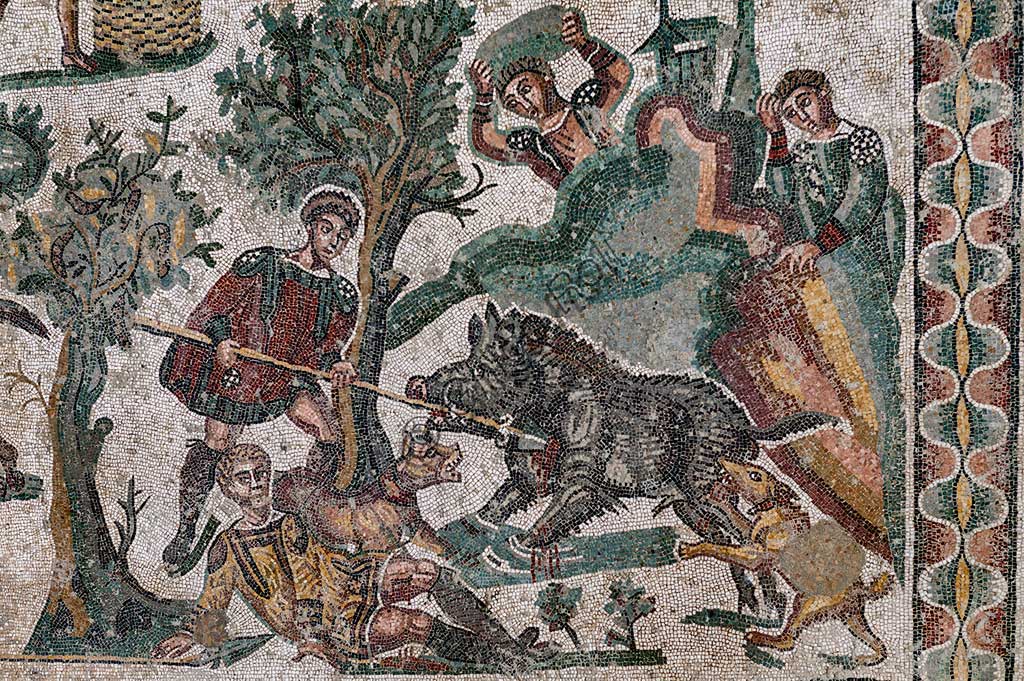 Piazza Armerina, Roman Villa of Casale, which was probably an imperial urban palace. Today it is a UNESCO World Heritage Site. Detail of the floor mosaic in the corridor of the Grat Hunt. Detail with  the capture of a  wild boar.In spite of the name with which it is known (The Great Hunt), the subject of the floor mosaic represents a great capture. It does not represent  hunting.Wild beasts are captured for the games in the amphitheatres of the Roman Empire: no animal is in fact shot down and hunters use only weapons to defend themselves.