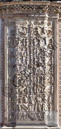  Orvieto, Basilica Cathedral of S. Maria Assunta (or Duomo): the façade, whose building started at the end of the XIII century.  Detail of the covering of the four pillars of the doors. These are marble slabs with bas-reliefs executed between 1320 and 1330 by Lorenzo Maitani with the help of Sienese and Pisan craftsmenSubject: continuation of biblical scenes with Messianic prophecies. The following themes develop between the acanthus spirals: Adam or Abraham asleep; King David, King Solomon, Roboamo, Abia, Asa, Giosafat; Mary and Christ. On the sides the prophets with their tables. The scenes represent: Balaam; the vocation of Joshua; the Miracle of Gideon; David anointed king; Presentation of Samuel to Elijah; The children of Israel in Egypt; the bread and wine prepared by Melchisedech for Abraham; Crucifixion.