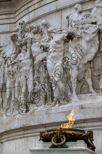  Rome, detail of the "Vittoriano" . The Altare della Patria (Altar of the Fatherland) also known as the Monumento Nazionale a Vittorio Emanuele II (National Monument to Victor Emmanuel II) or "Il Vittoriano" is a controversial monument built in honour of Victor Emmanuel, the first king of a unified Italy. It occupies a site between the Piazza Venezia and the Capitoline Hill.The eclectic structure was designed by Giuseppe Sacconi in 1885; sculpture for it was parceled out to established sculptors all over Italy, such as Leonardo Bistolfi and Angelo Zanelli. It was inaugurated in 1911 and completed in 1925.The monument is built of white marble from Botticino, Brescia, and features stairways, Corinthian columns, fountains, an equestrian sculpture of Victor Emmanuel and two statues of the goddess Victoria riding on quadrigas. The structure is 135 m (443 ft) wide and 70 m (230 ft) high. If the quadrigae and winged victories are included, the height is to 81 m (266 ft). The base of the structure houses the museum of Italian Unification.In 2007, a panoramic elevator was added to the structure, allowing visitors to ride up to the roof for 360 degree views of Rome.