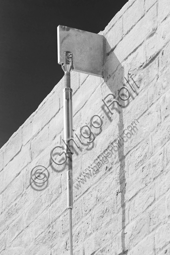  MEIS, National Museum of Italian Judaism and the Shoah in the town of Ferrara: detail of the façade and the surrounding wall flanked by a tree.The MEIS was realised in a building in via Piangipane which is part of the complex consisting of three blocks, enclosed by a double wall. The Museum is therefore the result of a work of conversion of the judicial prison in via Piangipane which was built between 1908 and 1912 based on a design by the engineers Bertotti and Facchini of the Civil Engineer Office. During the twenty years of fascism it became a place of detention for many anti-fascists. After the fall of the regime, on July 30,1943, 88 politic