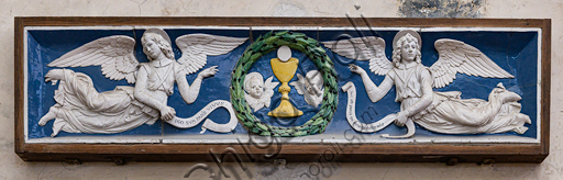 Basilica of the Holy Cross: "Two Angels adoring the Eucharist Chalice",  end XV century, by Andrea Della Robbia, lunette, bas-relief polychrome glazed terracotta.