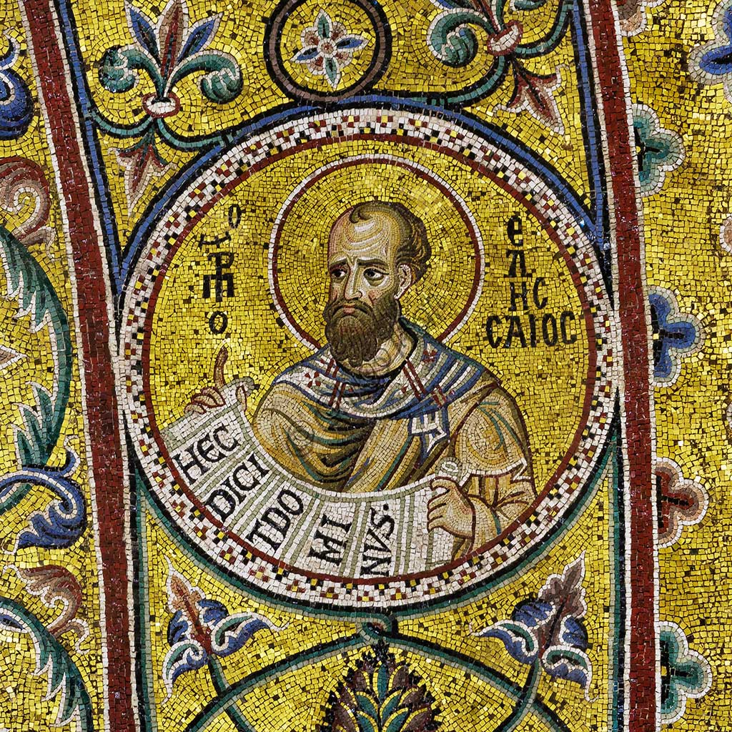 Duomo di Monreale, sottarco absidale: il Profeta Eliseo, mosaico di scuola bizantina su fondo oro. I mosaici del Duomo vennero eseguiti tra il XII e la metà del XIII secolo da maestranze in parte locali e in parte veneziane, formatesi alla scuola bizantina.